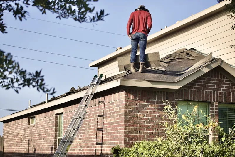 Professional roofer working on a residential roof in St. Helena